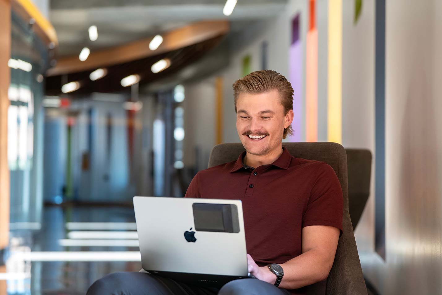 In a modern corridor, a student's focused study reflects focused learning in ASU's MS in Artificial Intelligence in Business program.