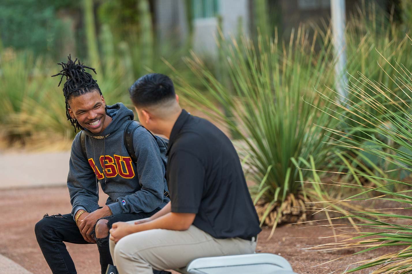 A friendly outdoor conversation surrounded by plants reflects collaboration and community in ASU's Applied Business and Technology Solutions degree.