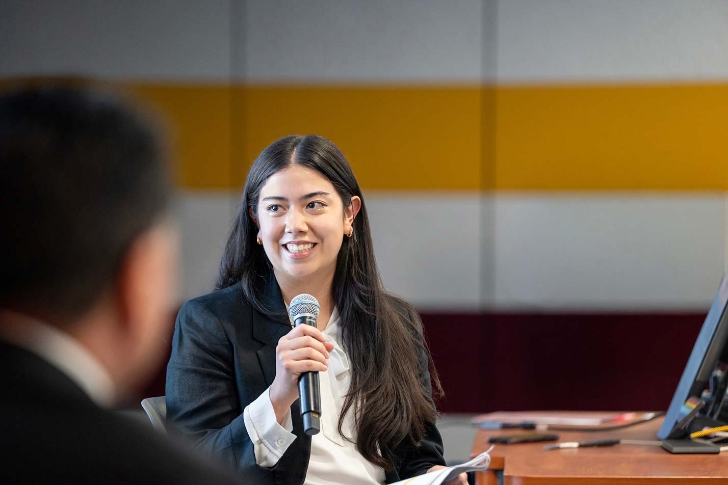 A student presents in an engaged discussion, highlighting leadership and communication skills essential in ASU's BA in Business (Language and Culture) degree.