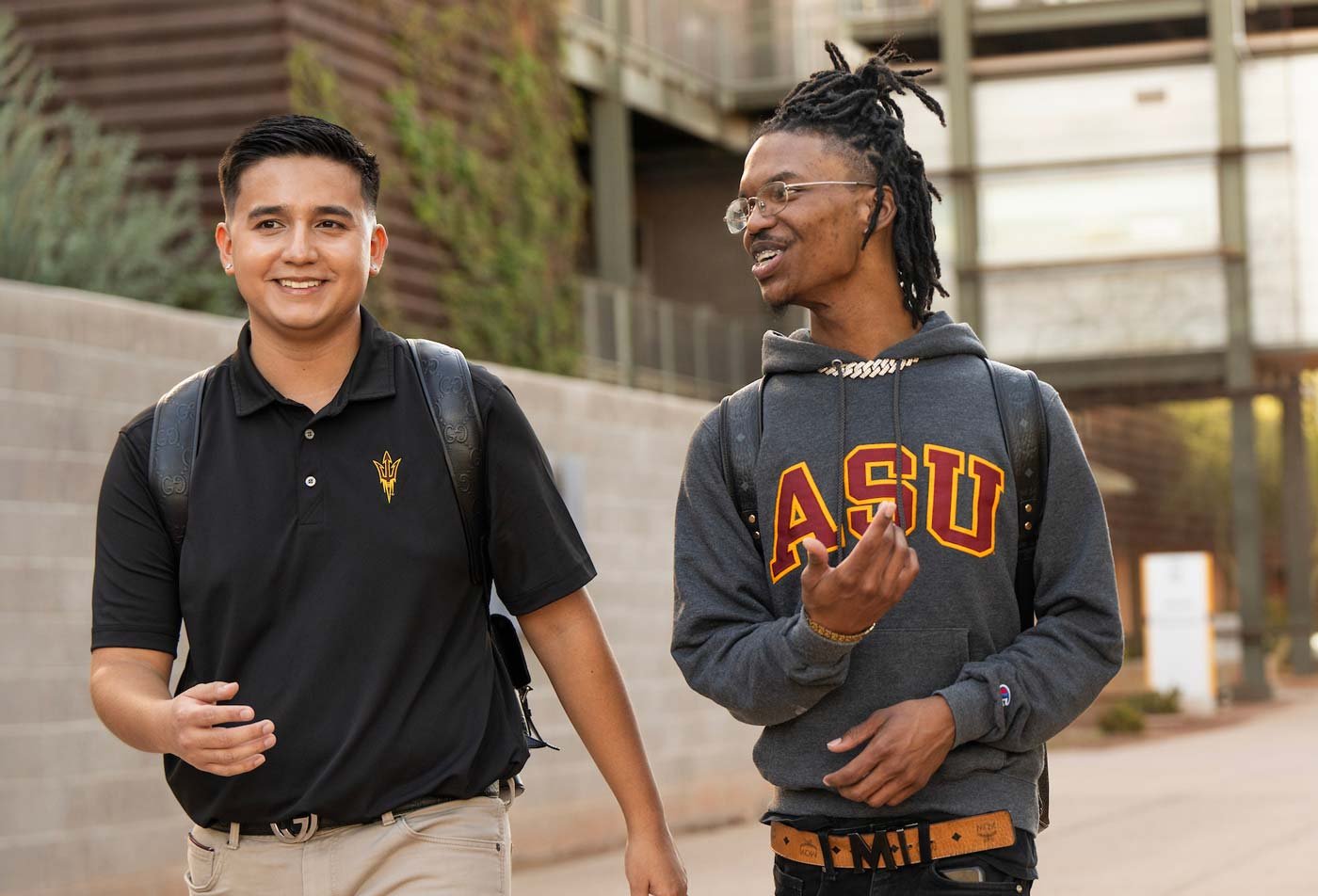 A casual chat unfolds while walking campus, showcasing a collaborative environment in ASU's Business (Human Resources) degree.