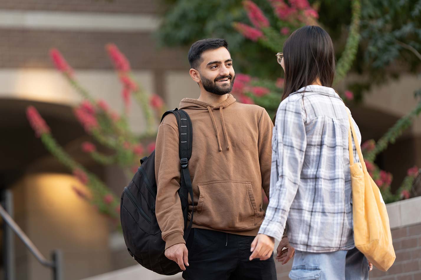 Surrounded by flowering plants, an outdoor chat highlights collaboration in ASU's Business (Information Security) degree.