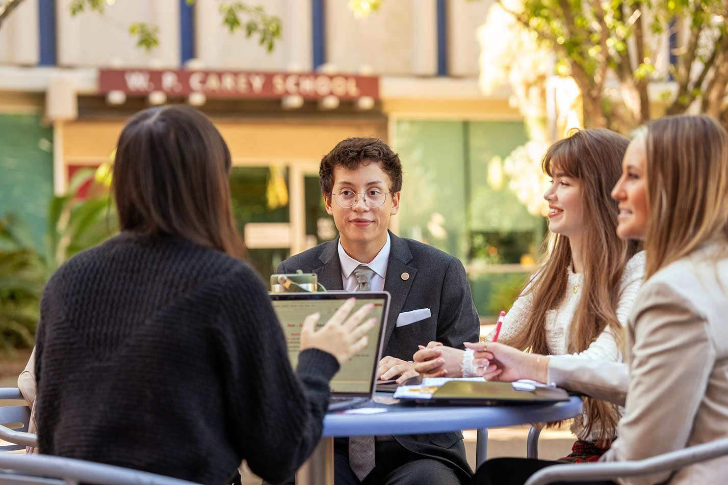 Around a table at W.P. Carey School, discussion among students illustrates teamwork in ASU's Business (Sustainability) program.