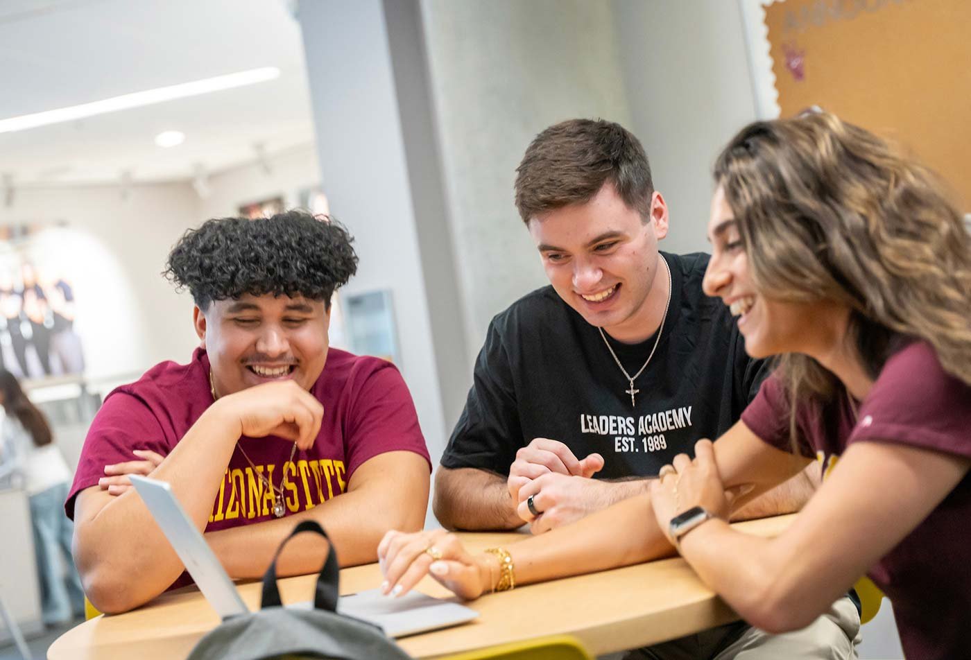 A table becomes a hub for collaborative studying as students work together on a project, demonstrating teamwork in ASU's Business (Statistics) degree.