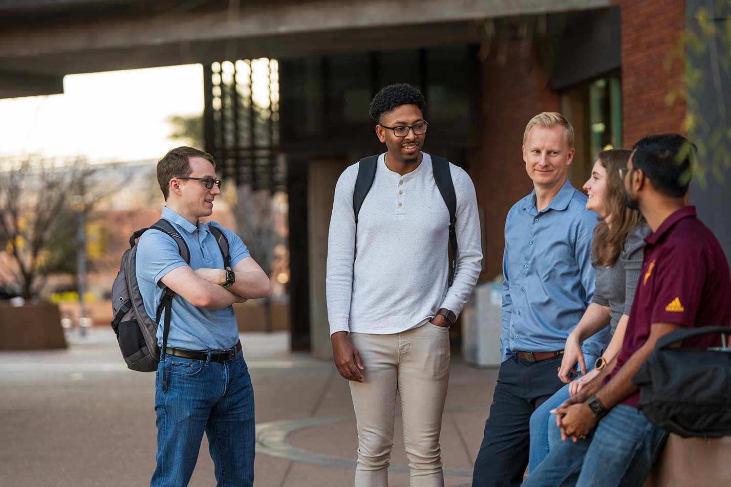 An outdoor conversation illustrates teamwork and collaboration in ASU's W. P. Carey MBA - Evening Program.