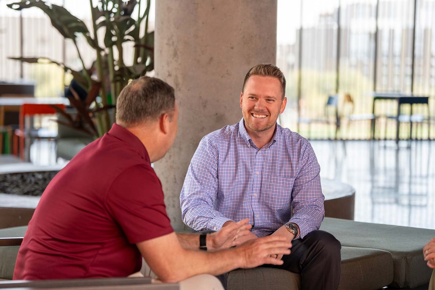 Conversation fills a well-lit space, emphasizing collaboration and networking in ASU's W. P. Carey MBA - Executive Program.