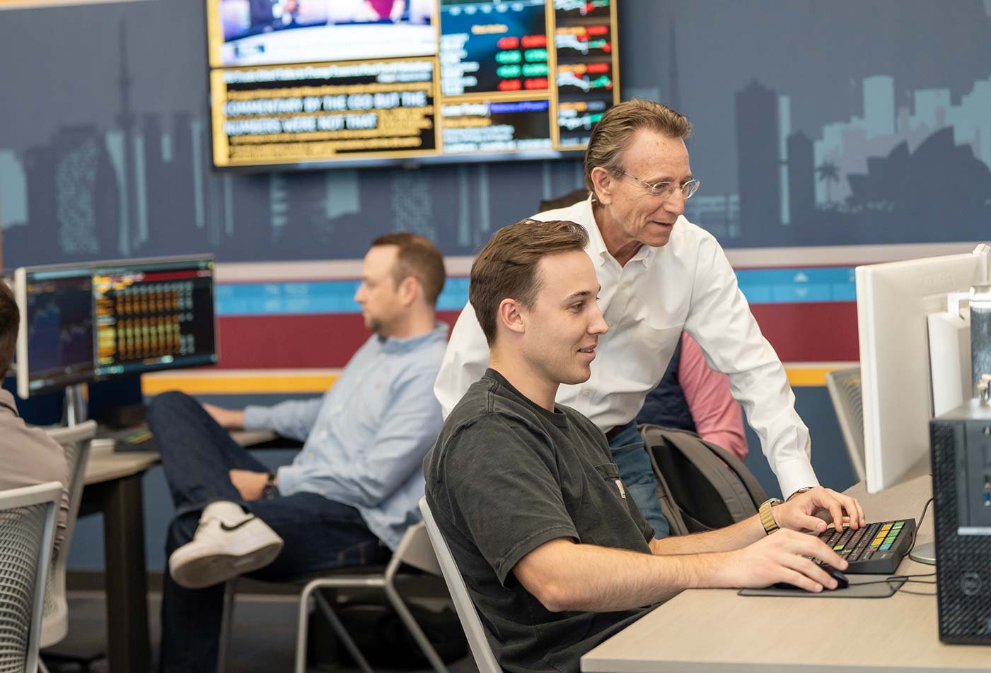 Students and faculty work together to produce real-time market analysis in a finance lab in ASU's Finance degree.