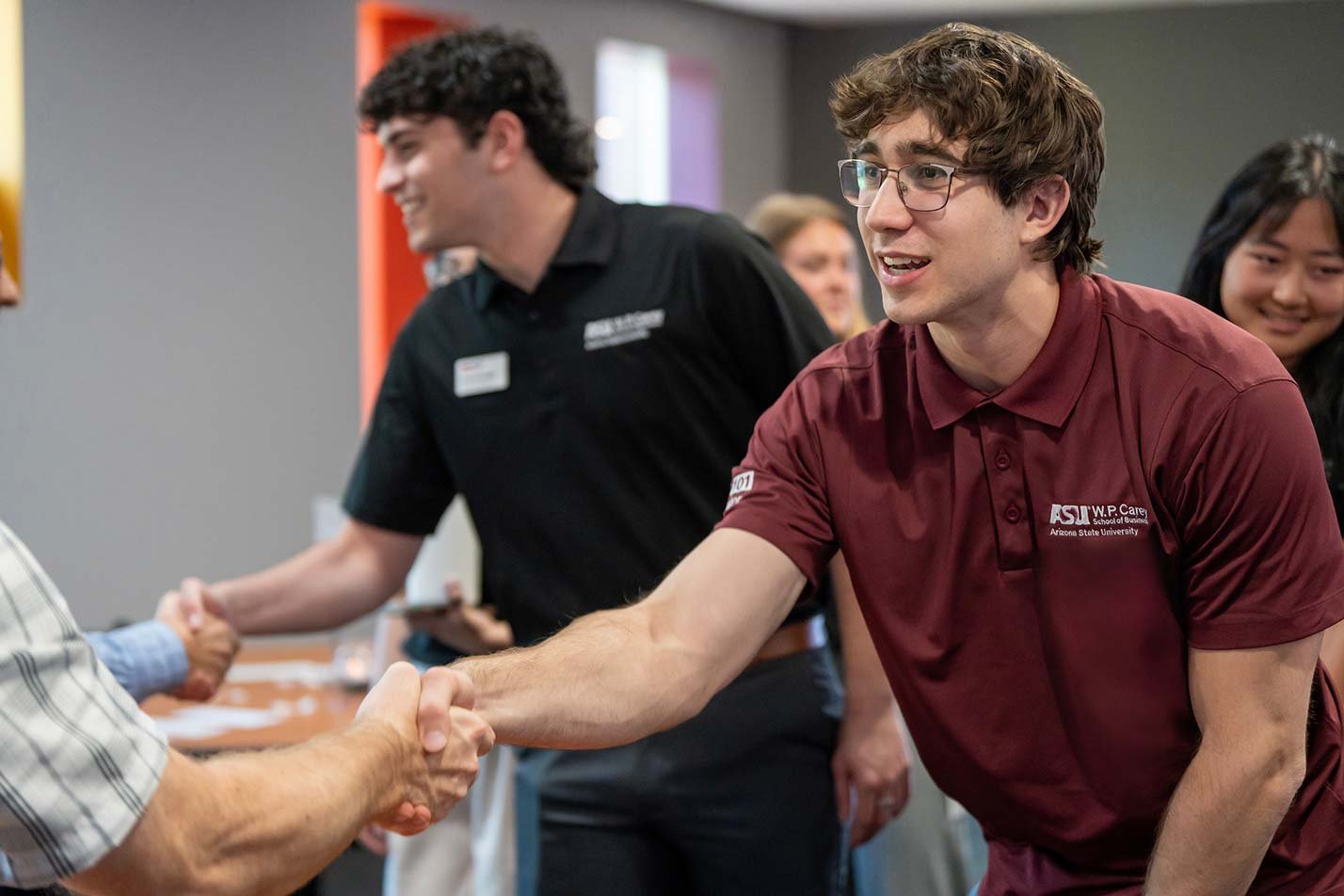 Students engage in networking at an event, demonstrating leadership skills learned through ASU's Leadership in Business certificate program.