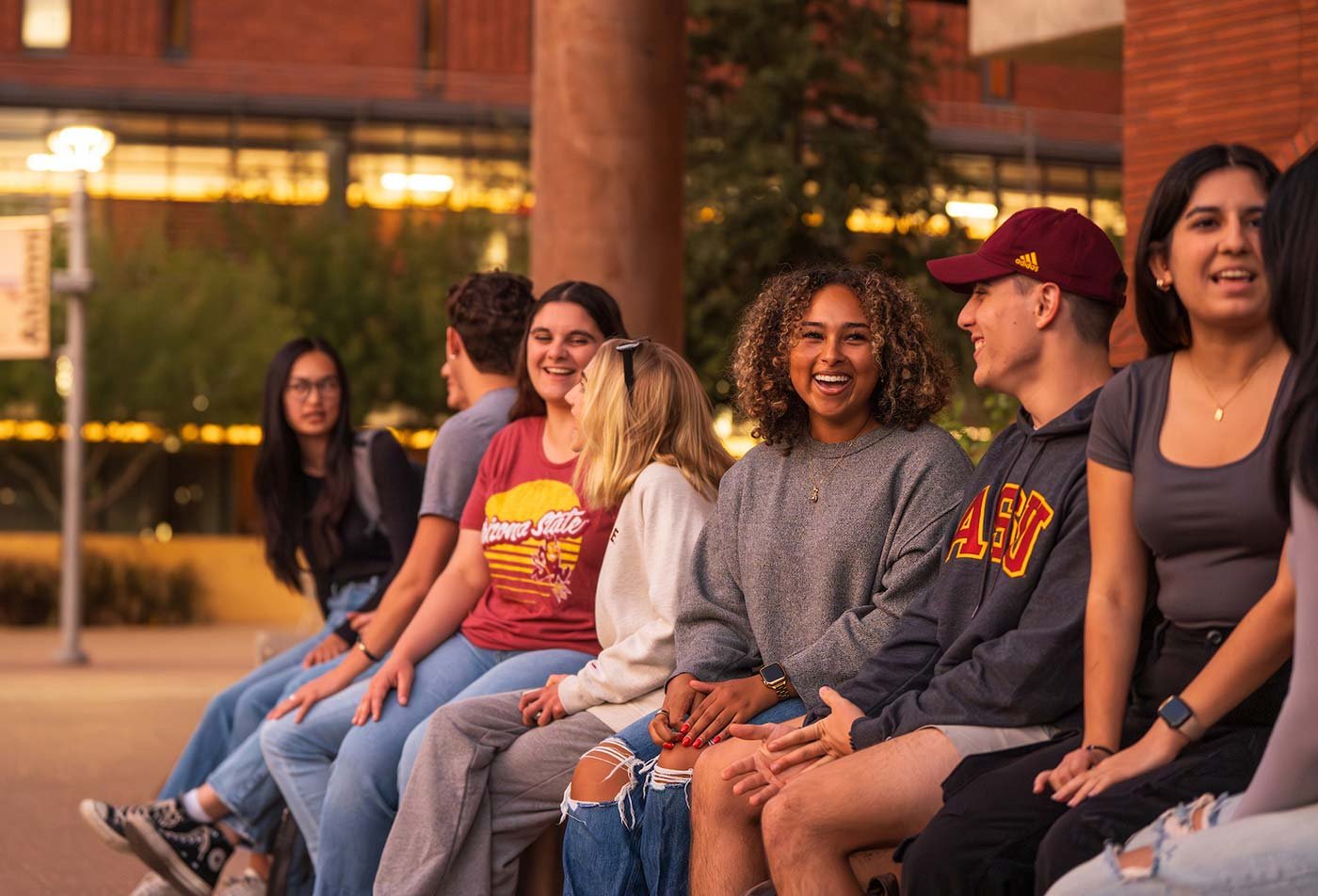 Students gather on campus for laughter and connection, showcasing community ties made through ASU's Real Estate minor program.