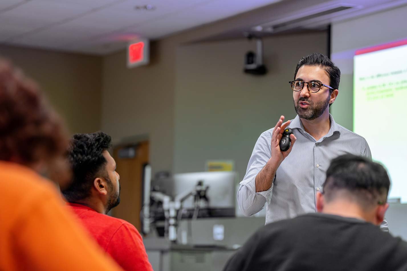 A professor explains concepts to an attentive classroom, showcasing engagement in ASU's Supply Chain Management, PhD program.