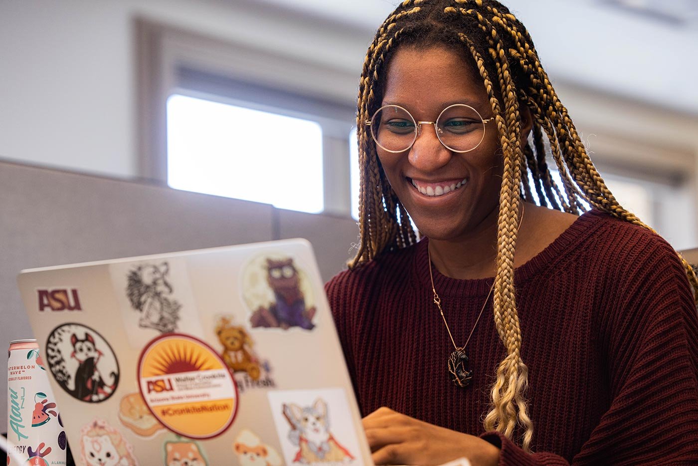 A student works on a laptop, illustrating the engaging projects in ASU's minor program in Media Analysis.