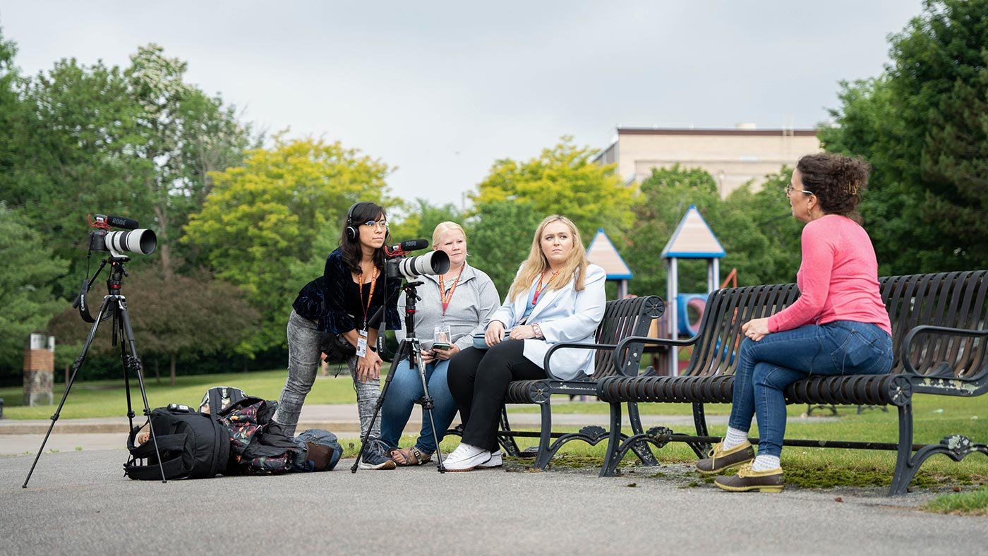 A student sets up cameras for an outdoor interview, actively engage in media production in ASU's minor program in media content creation.