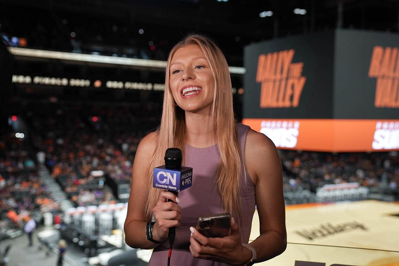 A student reports live at a sports event, showcasing practical skills learned in ASU's MS in Sports Journalism program.