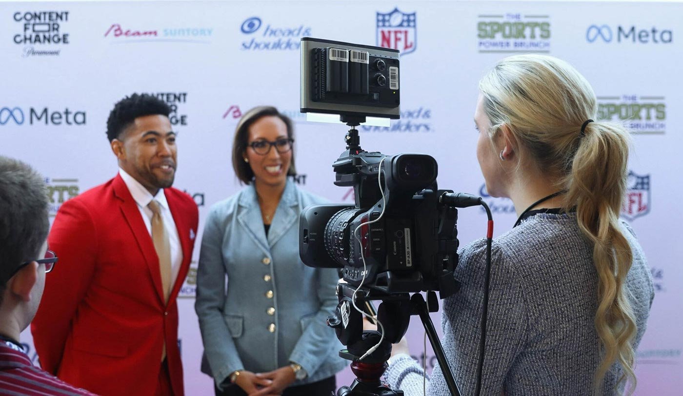 Students engage in an interview at a sports event, showcasing practical skills in ASU's MA in Sports Strategic Communication program.