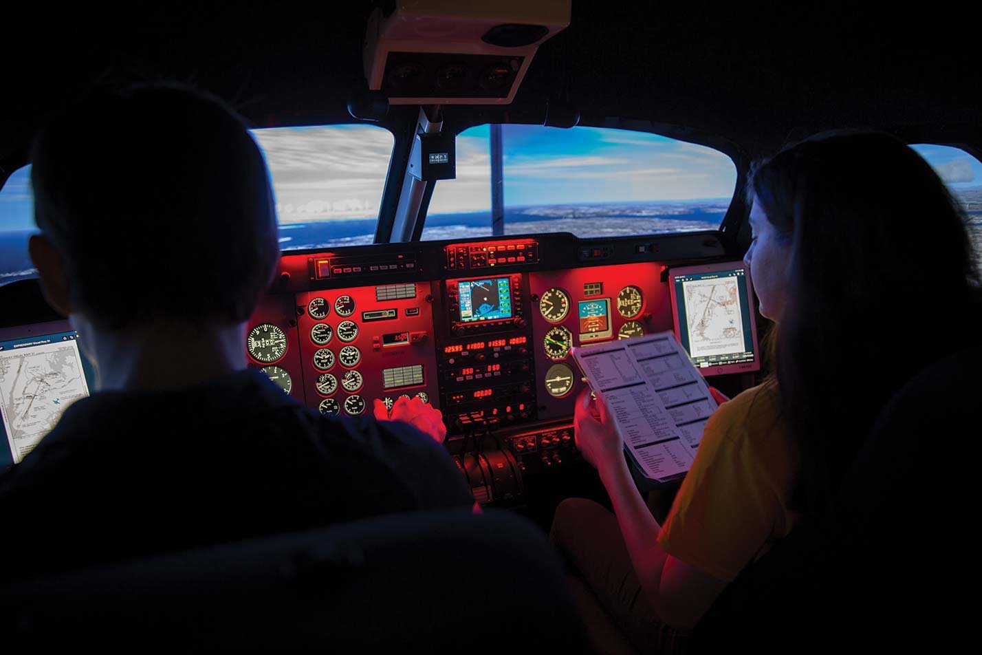 Students actively engaged in a flight simulator cockpit, enhancing their skills in ASU's Aerospace Engineering (Aeronautics) degree program.