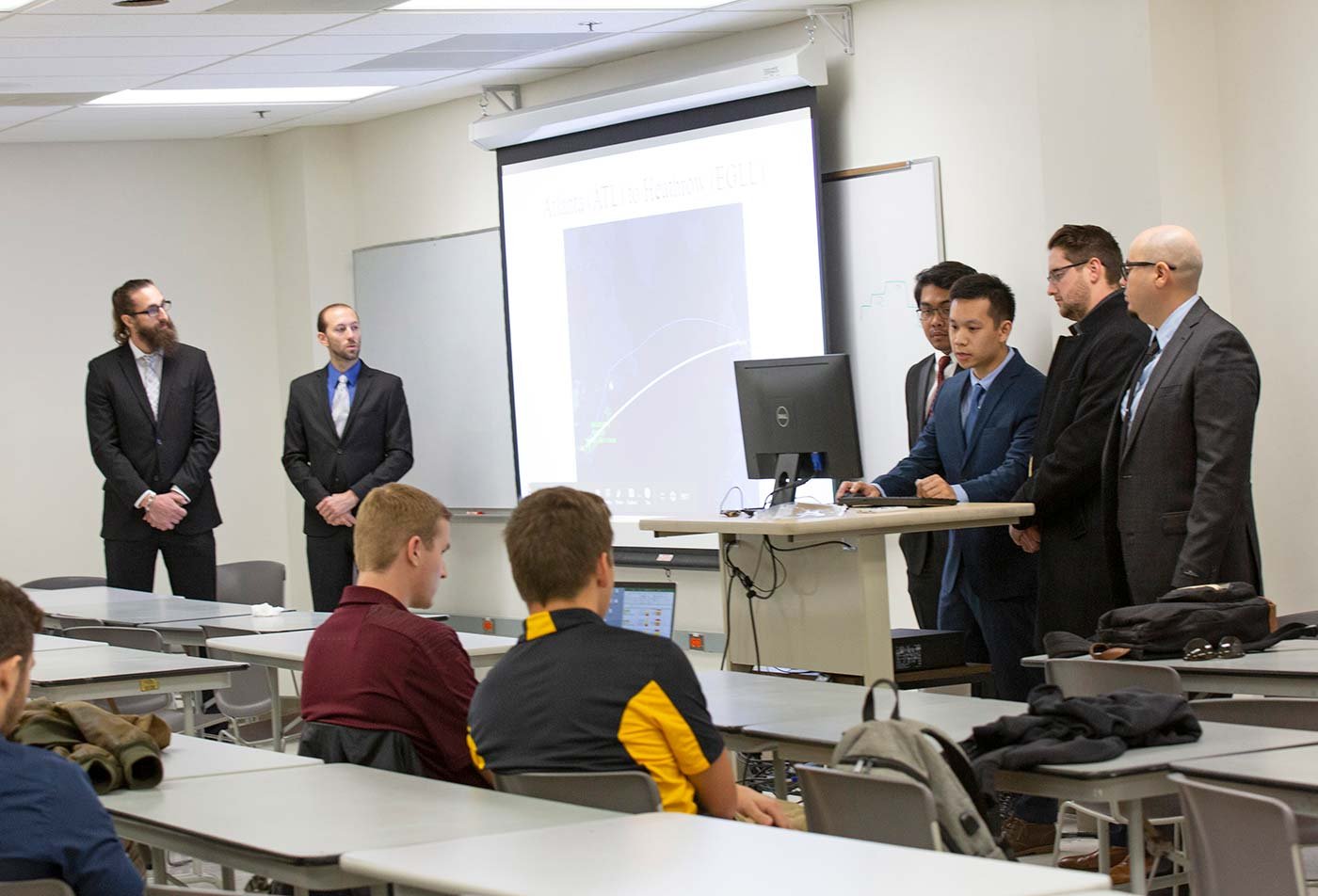Students present an aerospace project at a classroom table, reflecting the collaborative spirit of ASU's Aerospace Engineering program.