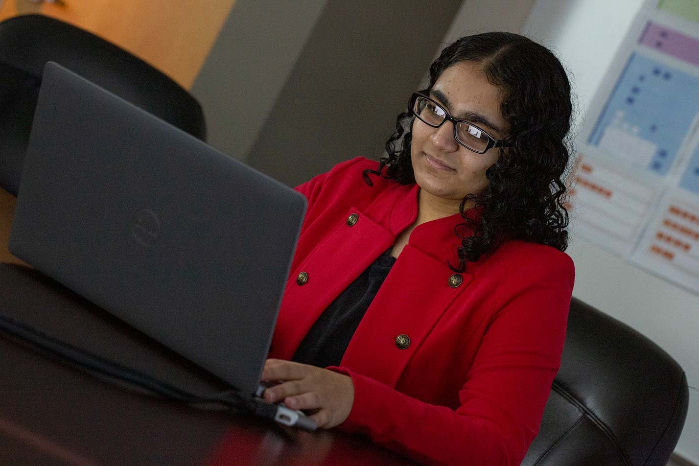 A student works confidently on a laptop, showcasing the focused learning in ASU's Artificial Intelligence Engineering (Chemical Engineering) program.