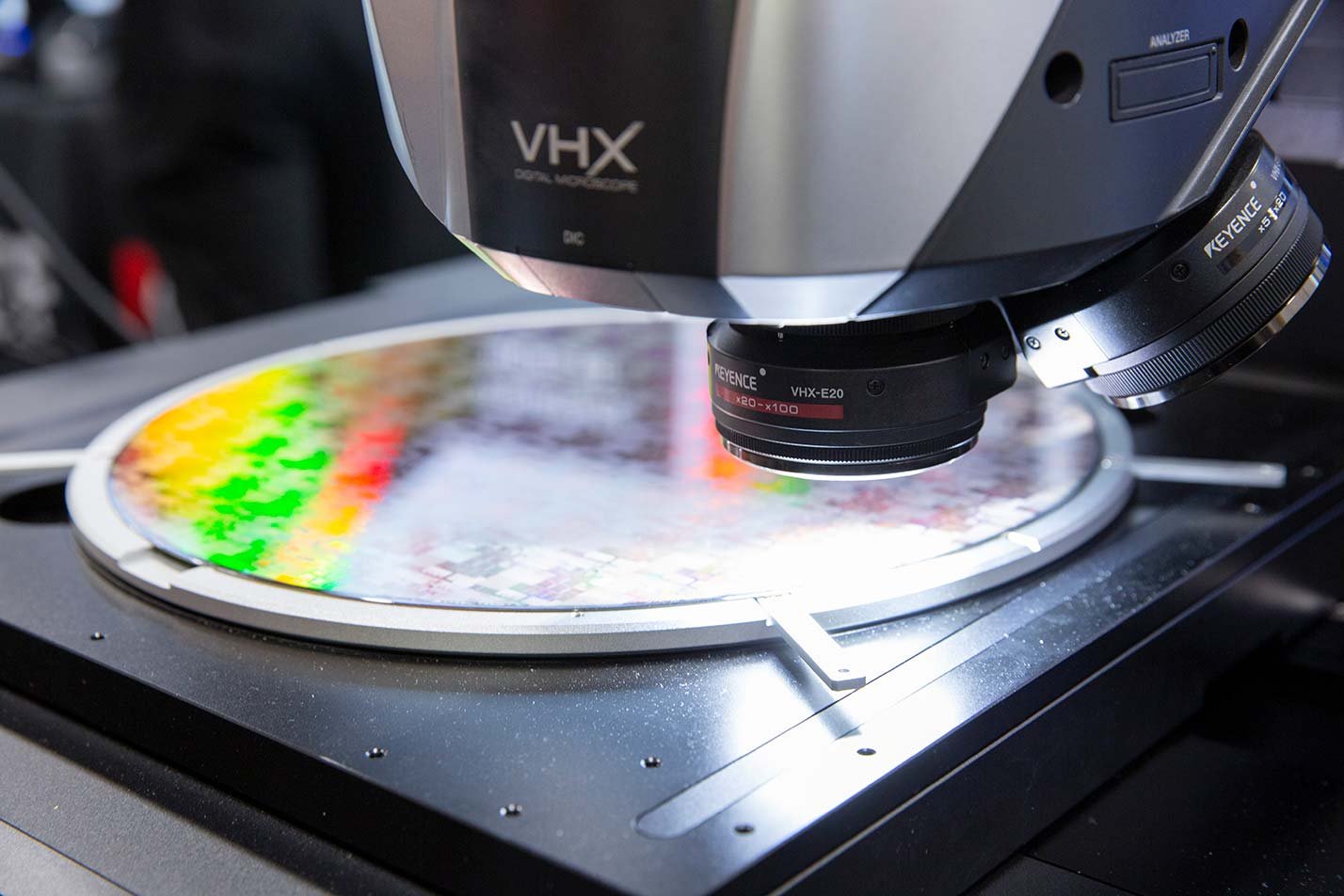 A microscope captures a colorful microchip wafer, showcasing the innovative experiences in ASU's MS in Artificial Intelligence Engineering (Electrical Engineering) degree.