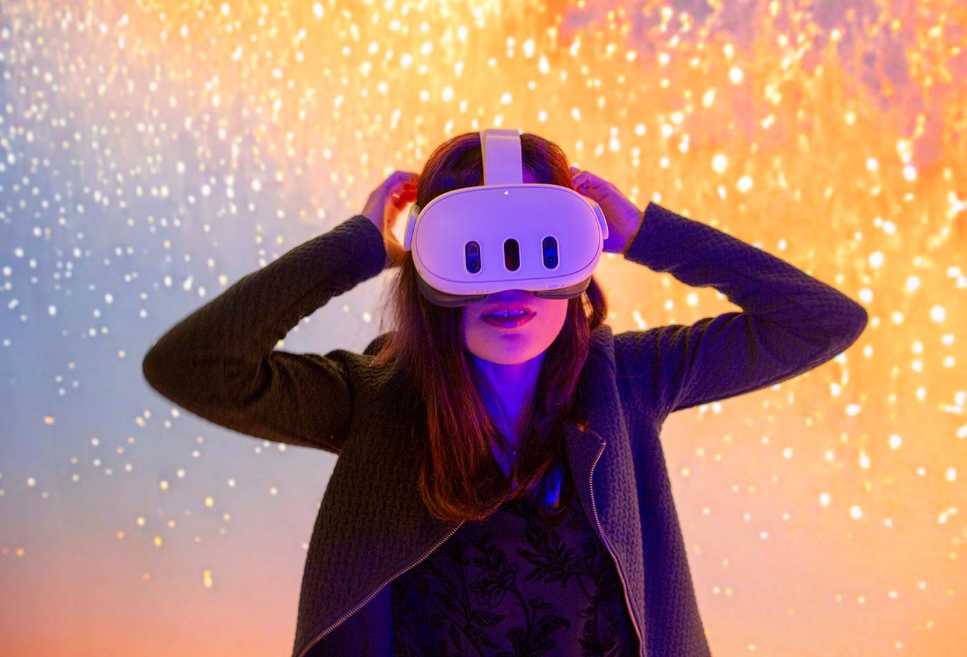 A person in a virtual reality headset stands before a colorful background, highlighting engagement in ASU's Artificial Intelligence, PhD degree.
