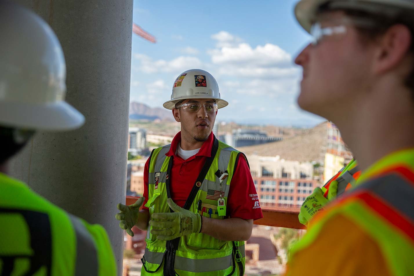 Students engaged in discussion at a construction site, showcasing practical learning in ASU's Civil Engineering degree.