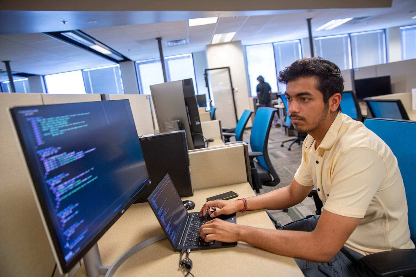 Student engages in coding and collaboration, highlighting hands-on experiences in ASU's Computer Engineering (Computer Systems) PhD program.