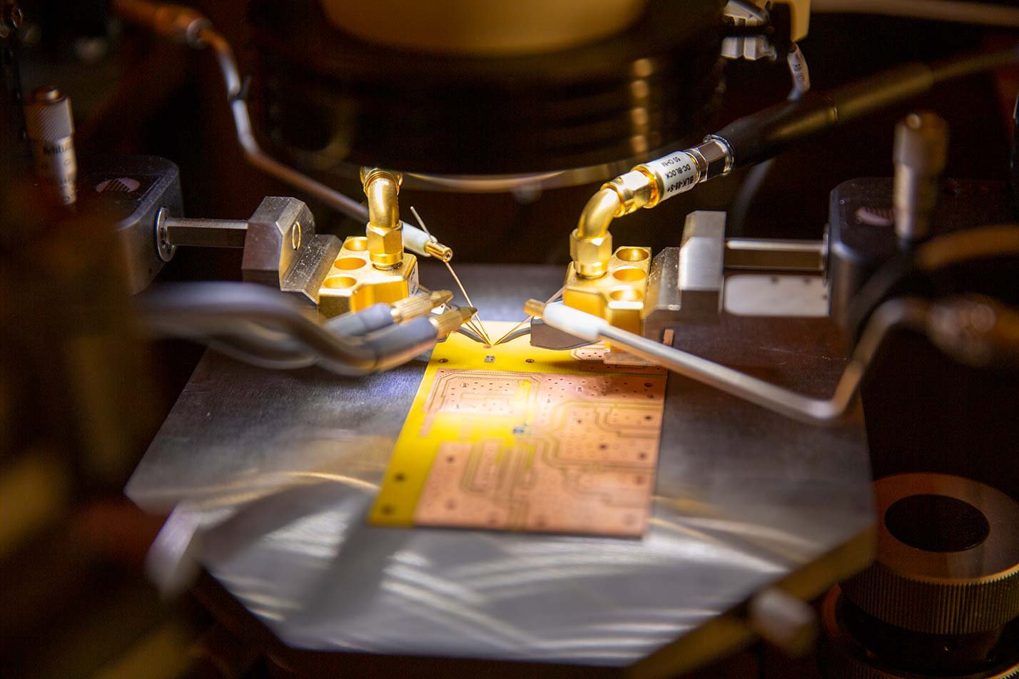 Microchips are precisely manipulated under a microscope, showcasing the advanced techniques utilized in ASU's MS in Computer Engineering program.