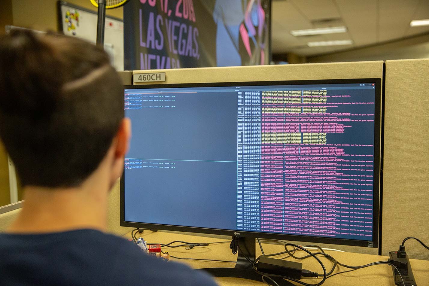 A focused individual observes lines of code and data on a computer screen, highlighting practical skills in ASU's Informatics program.