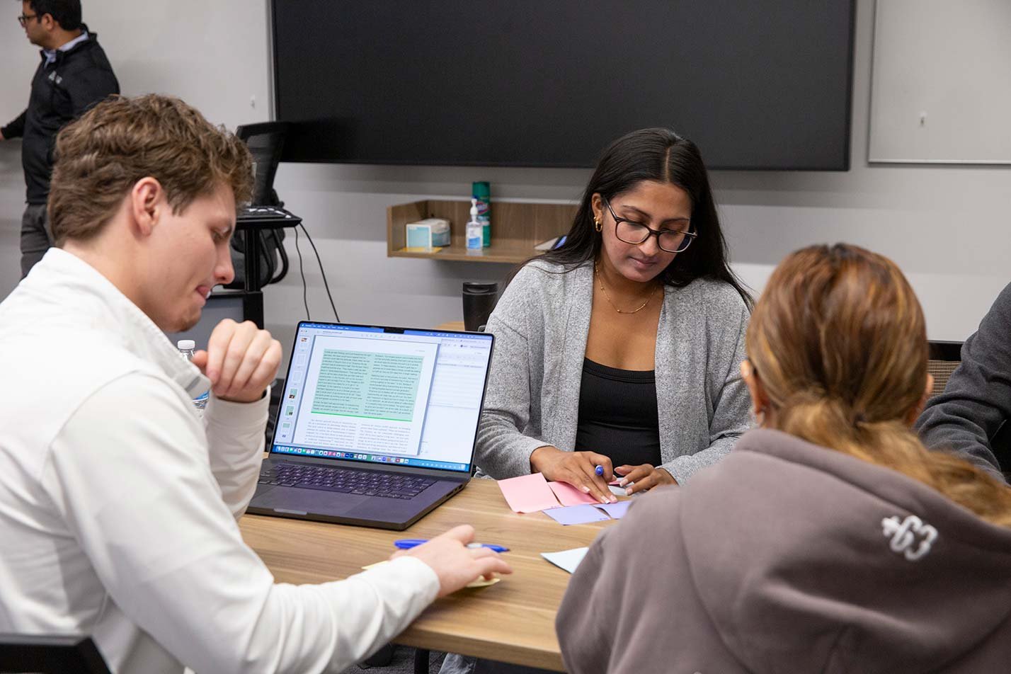 Students brainstorm with sticky notes and laptops, driving collaborative research in ASU's Computer Science (Biomedical Informatics) degree.