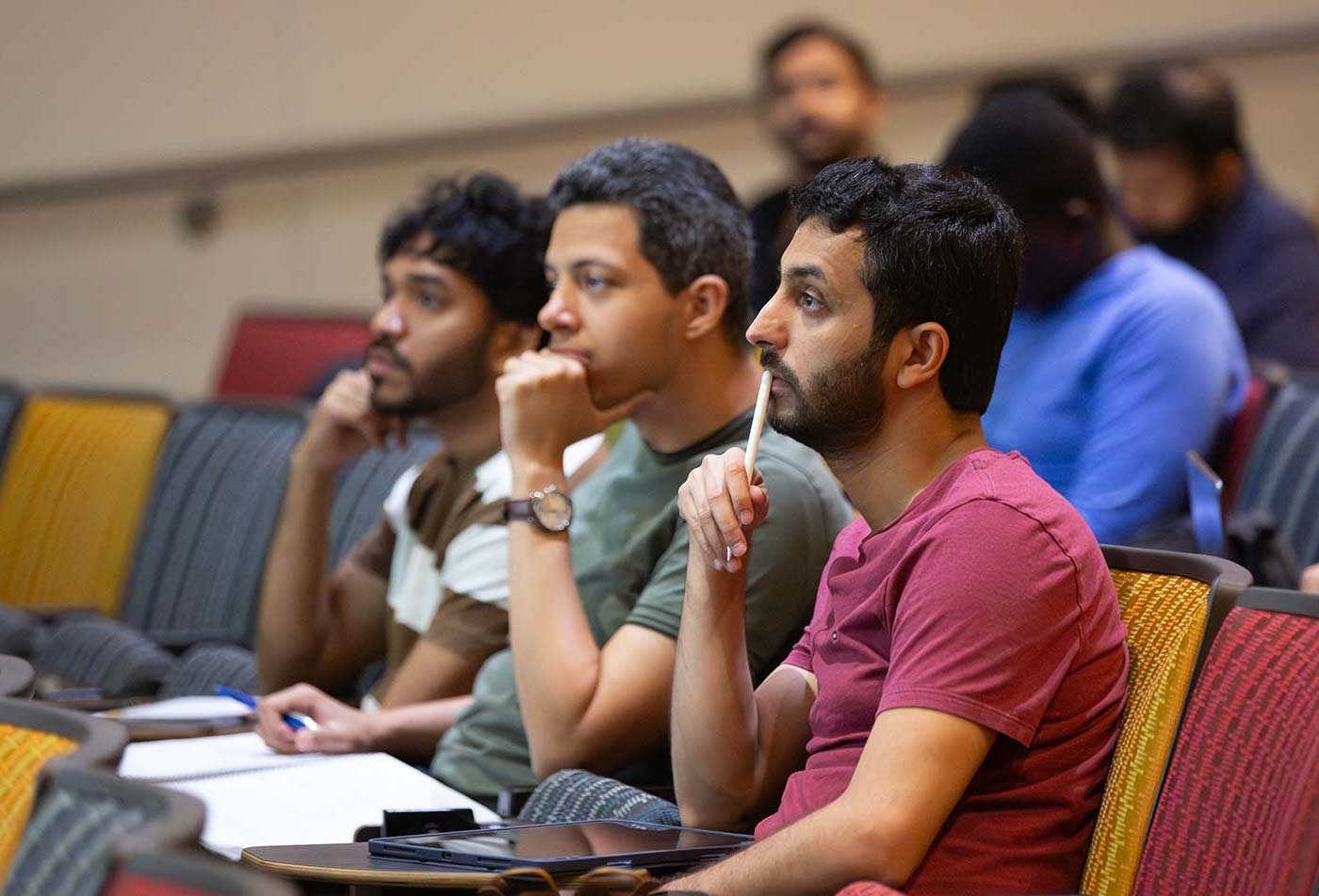 Students listen during a classroom lecture, representing advanced learning in ASU's Computer Science (Cybersecurity) degree.