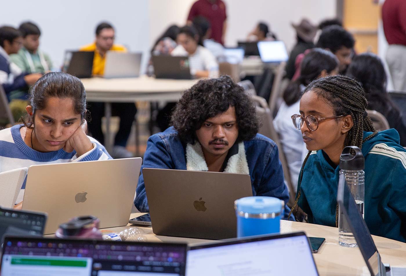 Students engage in collaborative coding in a modern classroom, showcasing teamwork in ASU's Computer Science (Software Engineering) degree.