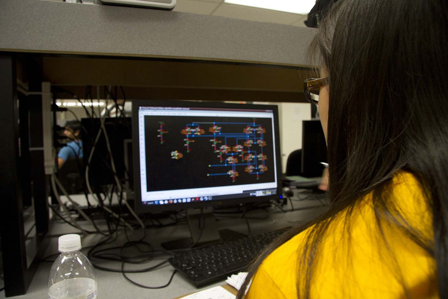 A student reviews circuit designs on-screen in ASU's Data Science, Analytics and Engineering (Electrical Engineering), MS degree.