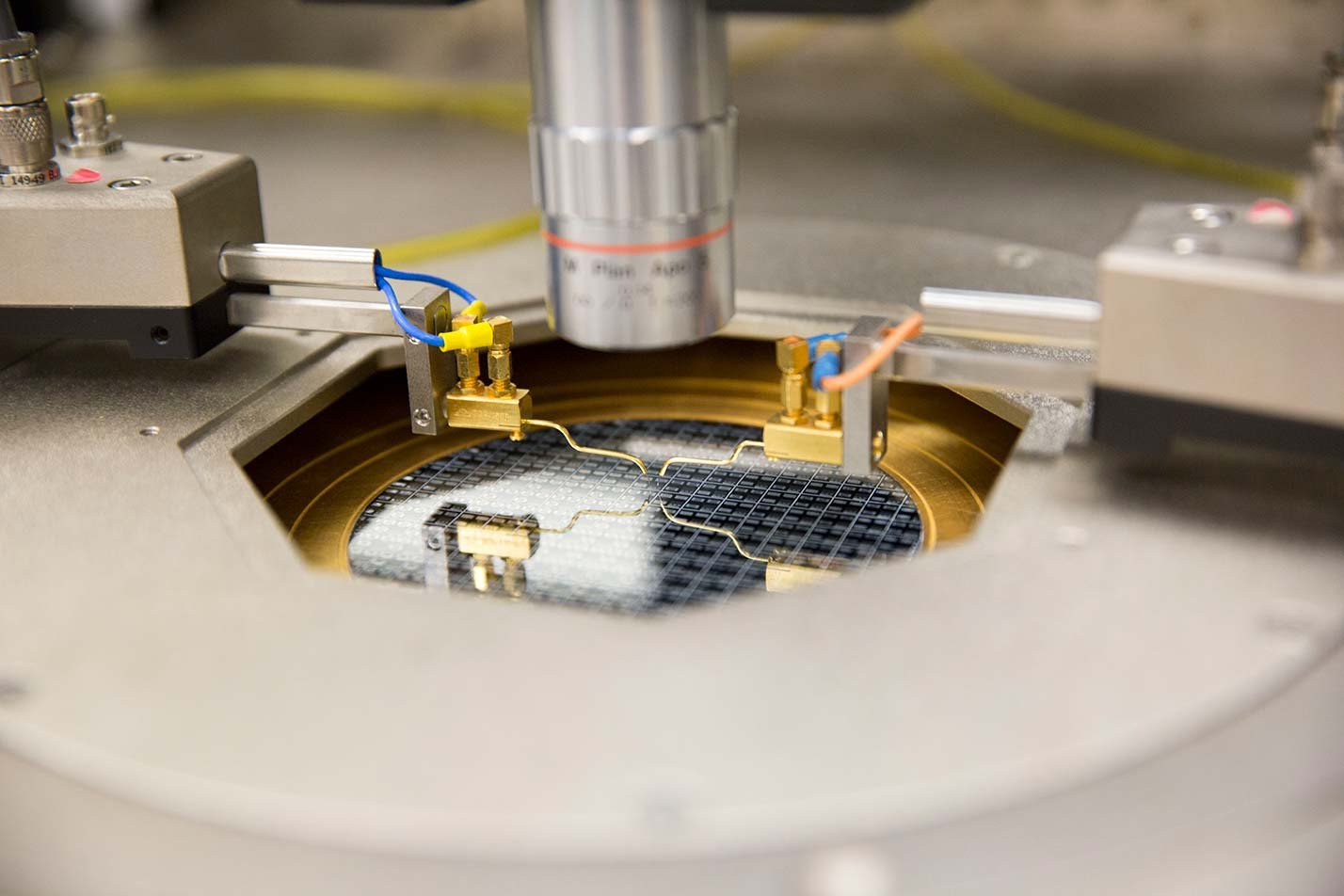 A semiconductor wafer undergoes precision testing, showcasing hands-on research in ASU's Electrical Engineering, MSE degree.