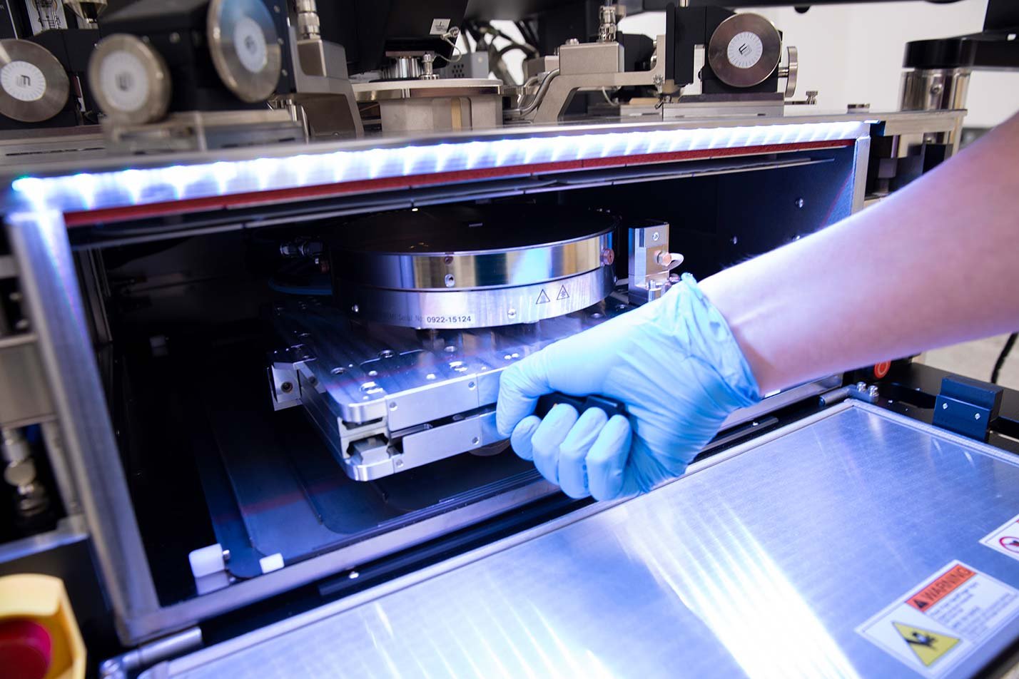 A researcher operates advanced semiconductor equipment, showcasing hands-on innovation in ASU's Electrical Engineering, PhD program.