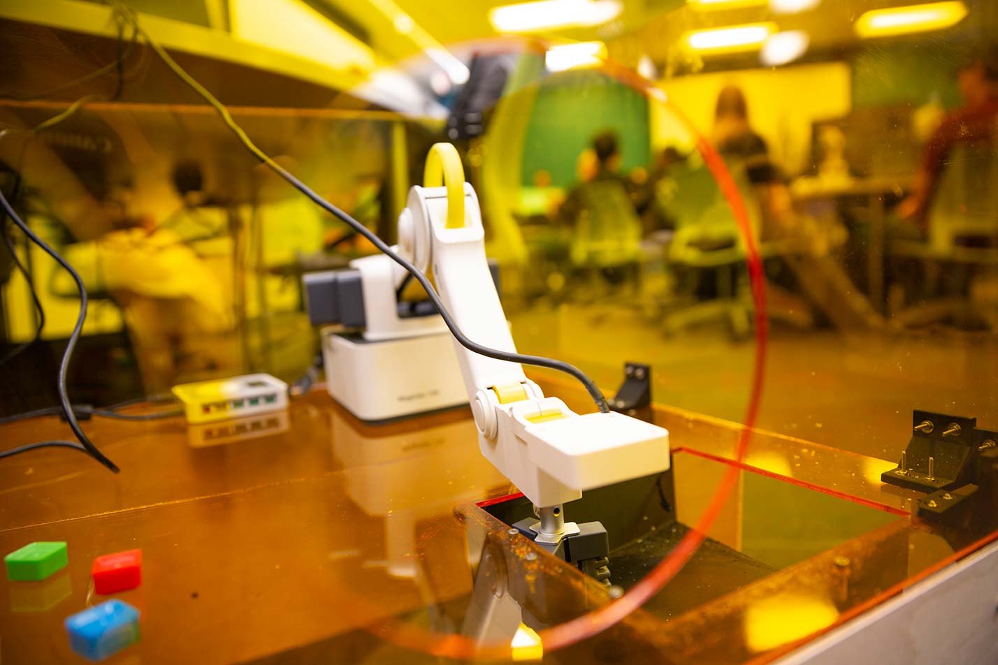 A robotic arm performs a precision task in a laboratory, highlighting applied engineering in ASU's Engineering, MS program.