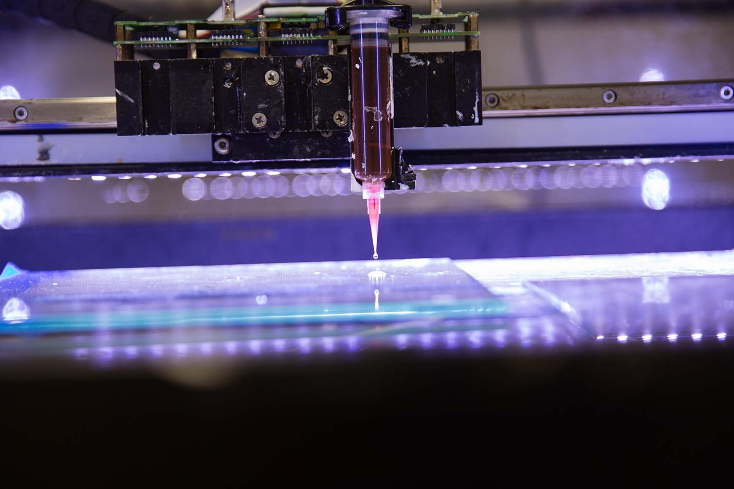 A precision deposition system applies material to a surface, showcasing advanced research in ASU's Materials Science and Engineering, PhD program.