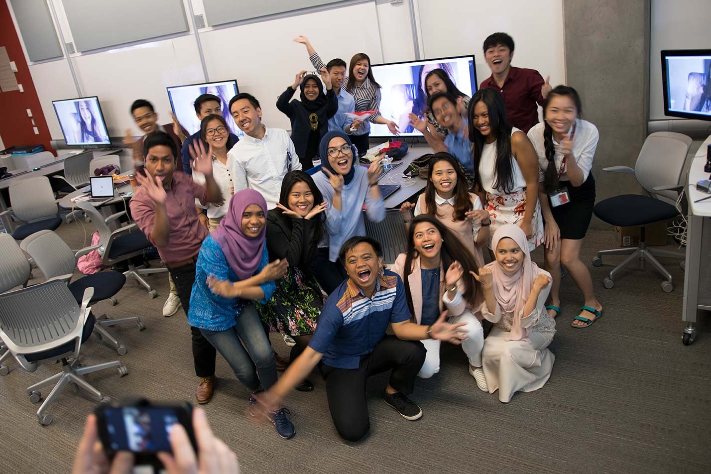 Students celebrate together in a classroom, highlighting teamwork in ASU's Global Engineering program.