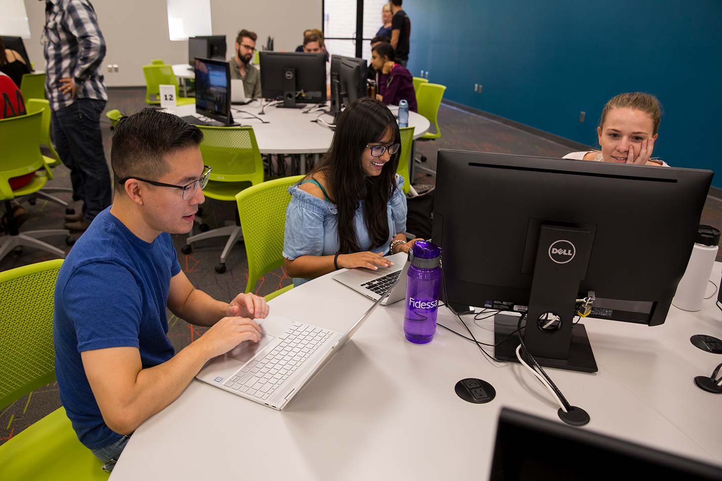 Students work together in a computer lab, showcasing collaborative work in ASU's Graphic Information Technology (Full-Stack Web Development) degree.