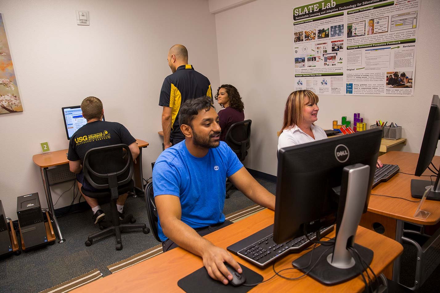 Students collaborate in a computer lab environment, illustrating interactive learning in ASU's Human Systems Engineering (User Experience) program.