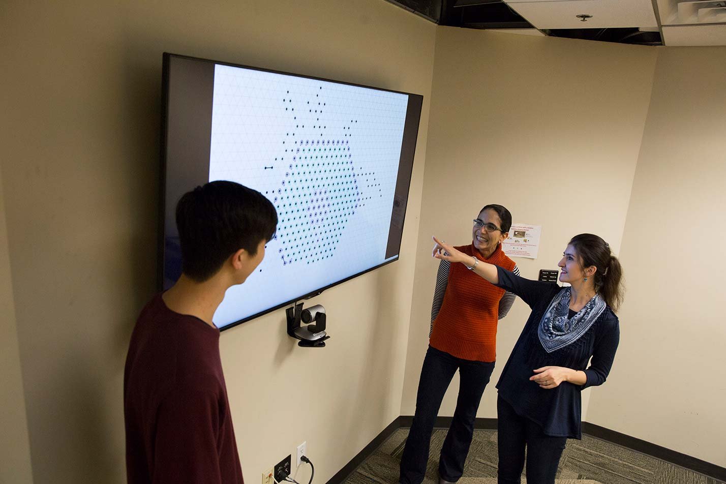Students present ideas around a digital display, showcasing design in ASU's Human Systems Engineering (User Experience Research), MS program.