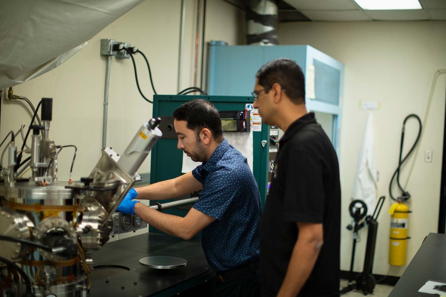 Researchers operate advanced laboratory equipment, highlighting hands-on experimentation in ASU's Mechanical Engineering, MS program.