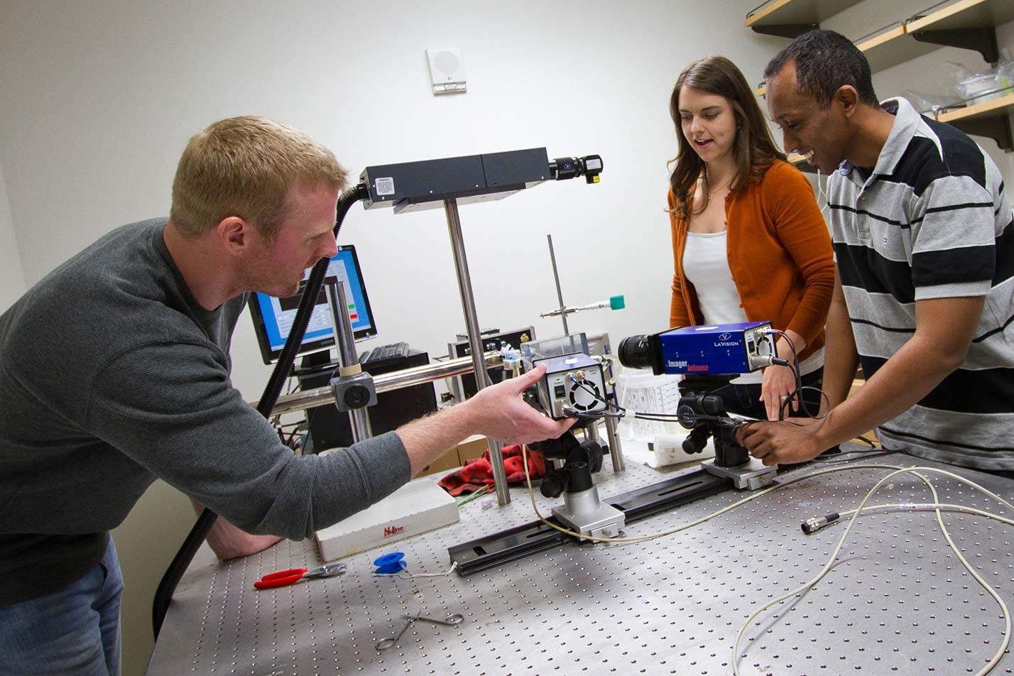 Researchers align optical equipment, highlighting biomedical innovation in ASU's Robotics and Autonomous Systems (Biomedical Engineering), MS program.