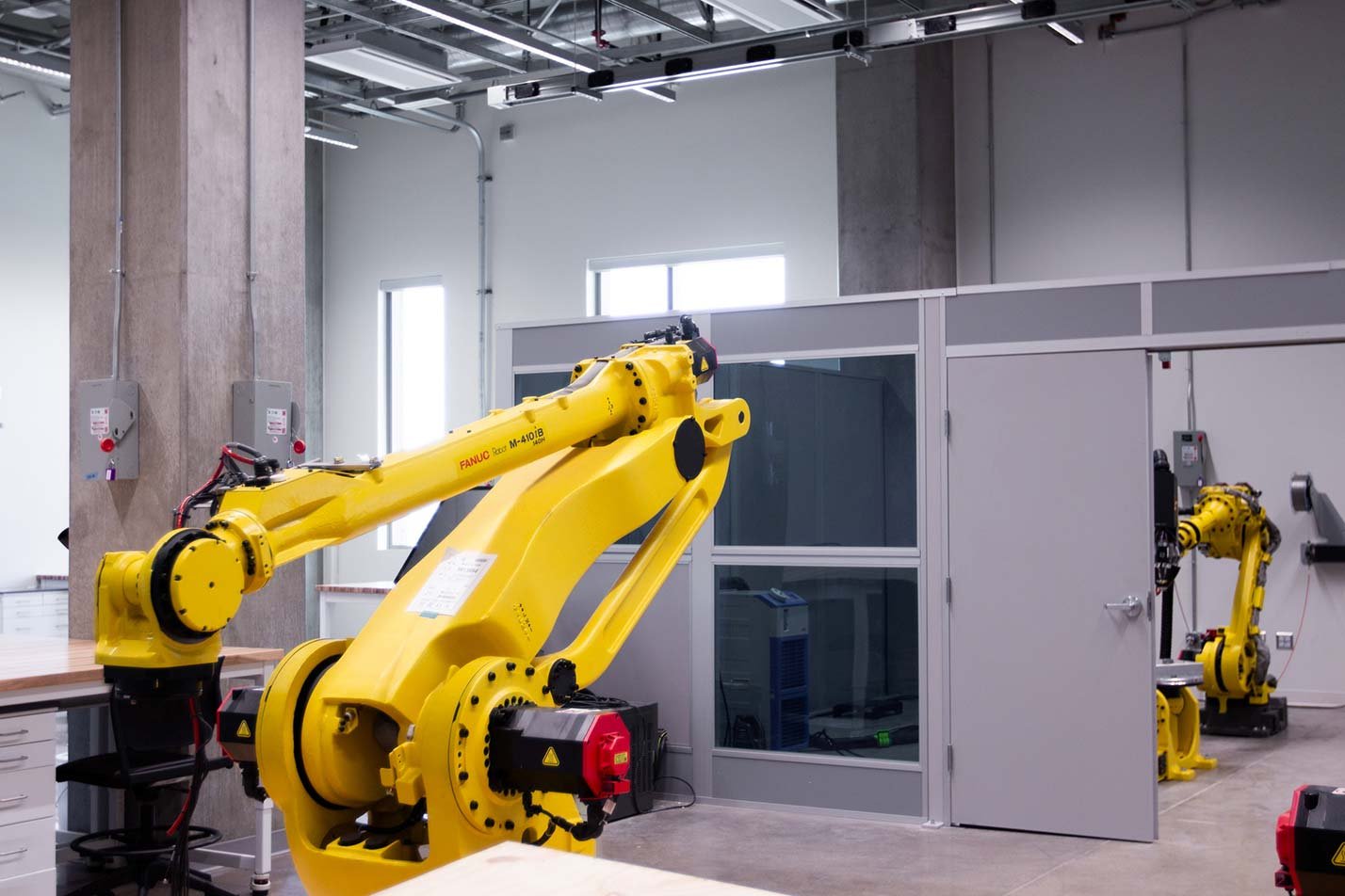 Industrial robotic arms operate in a lab, showcasing systems integration in ASU's Robotics and Autonomous Systems (Systems Engineering), MS program.