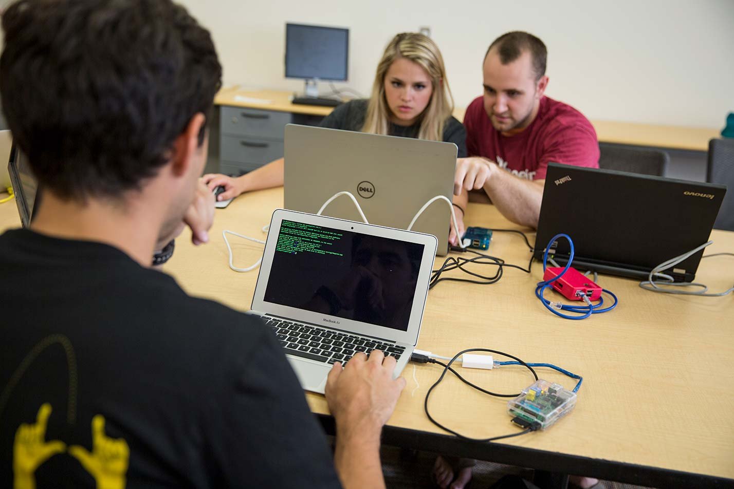 Students collaborate on secure software development, highlighting practical skills in ASU's Software Engineering (Cybersecurity), MS program.