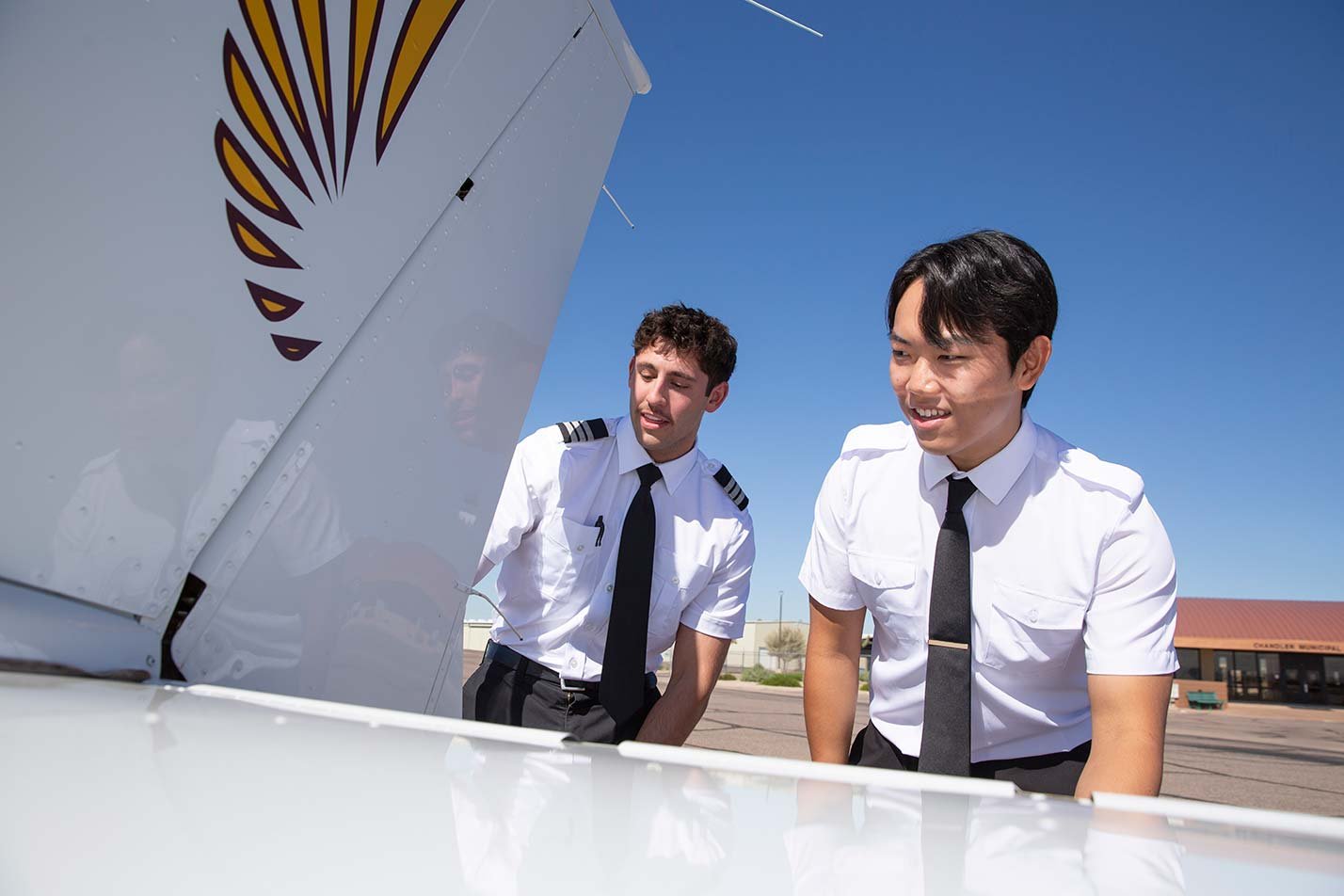 Students examine an aircraft's tail while gaining practical experience in ASU's Applied Science (Aviation) degree.