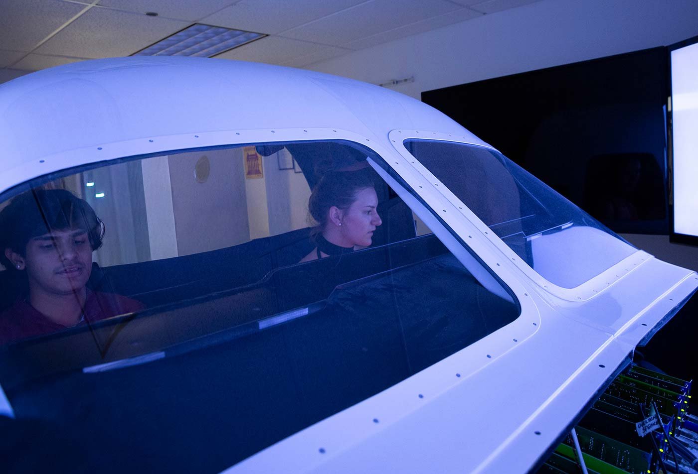 Students train in a flight simulator, demonstrating aviation technology in ASU's Technology (Aviation Management and Human Factors), MSTech program.