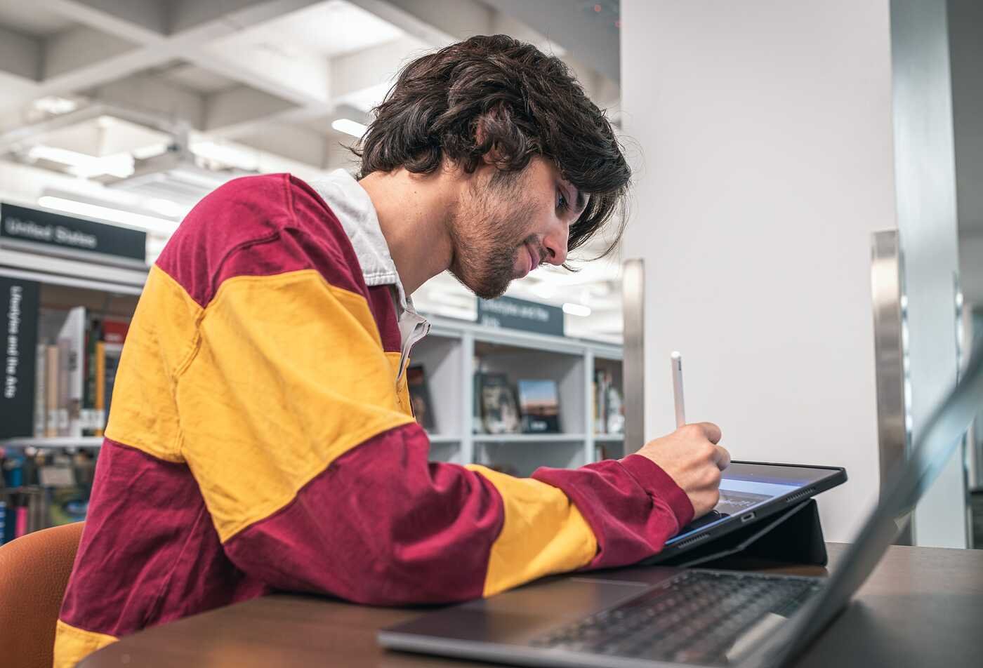Arizona State University Innovation in Society student from the Rob Walton College of Global Futures utilizing AI tools as part of his experience working with ASU's Enterprise Technology