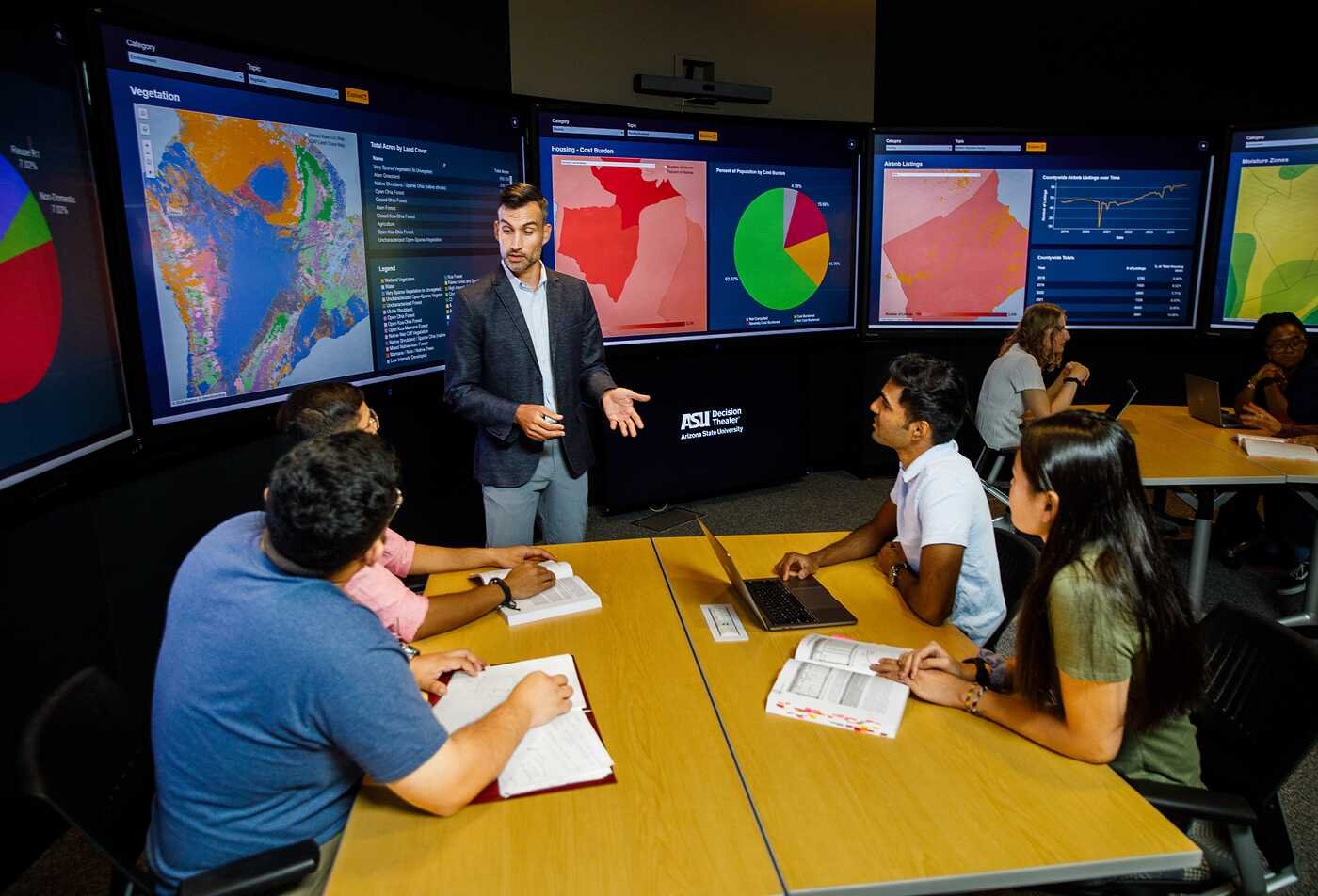 Complexity Science students from ASU's Rob Walton College of Global Futures listening to a faculty member from the Decision Theater