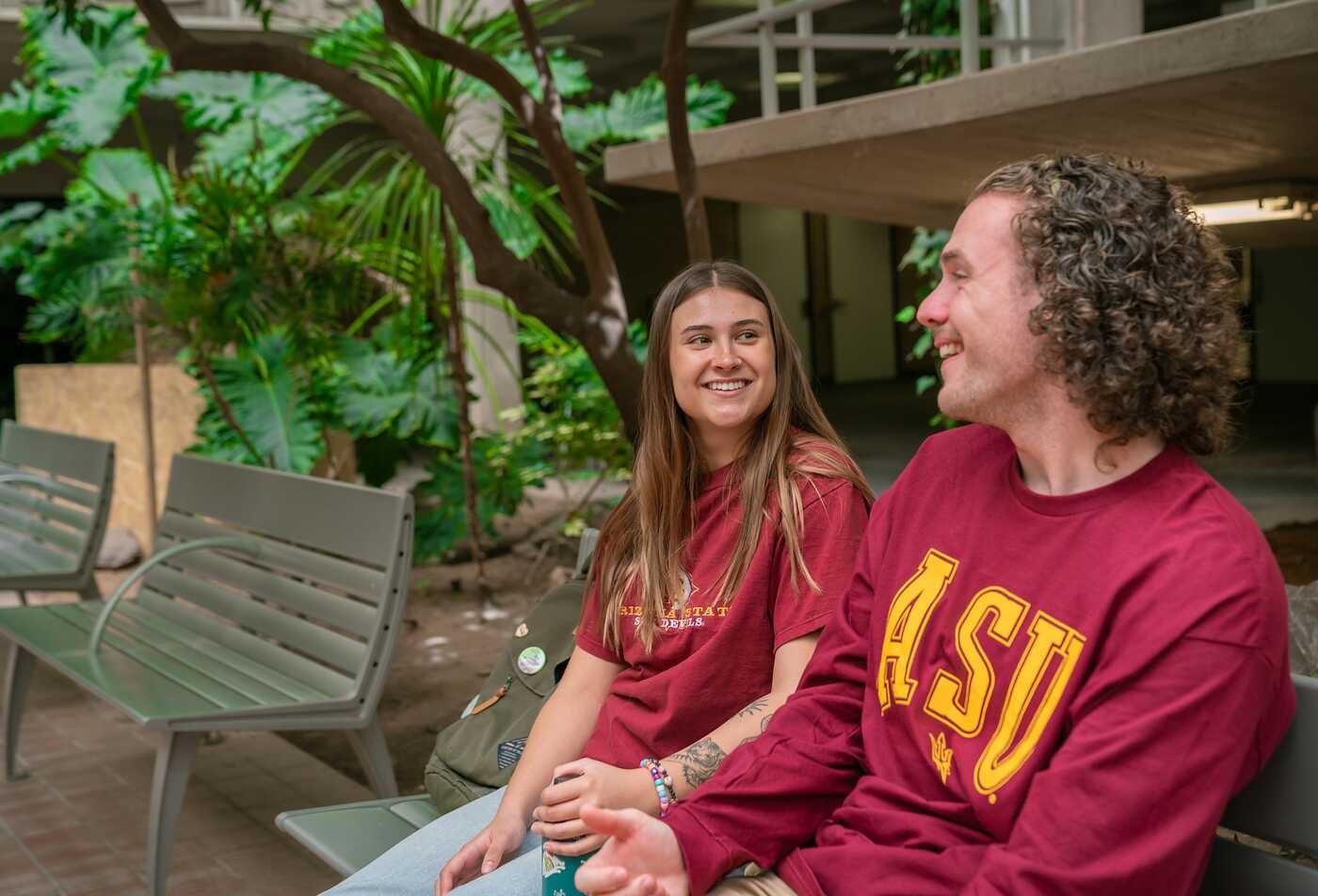 Arizona State University sustainability students in ASU Rob Walton College of Global Futures having a conversation amongst trees on the Tempe campus at the unviersity ranked number 1 for sustainability.