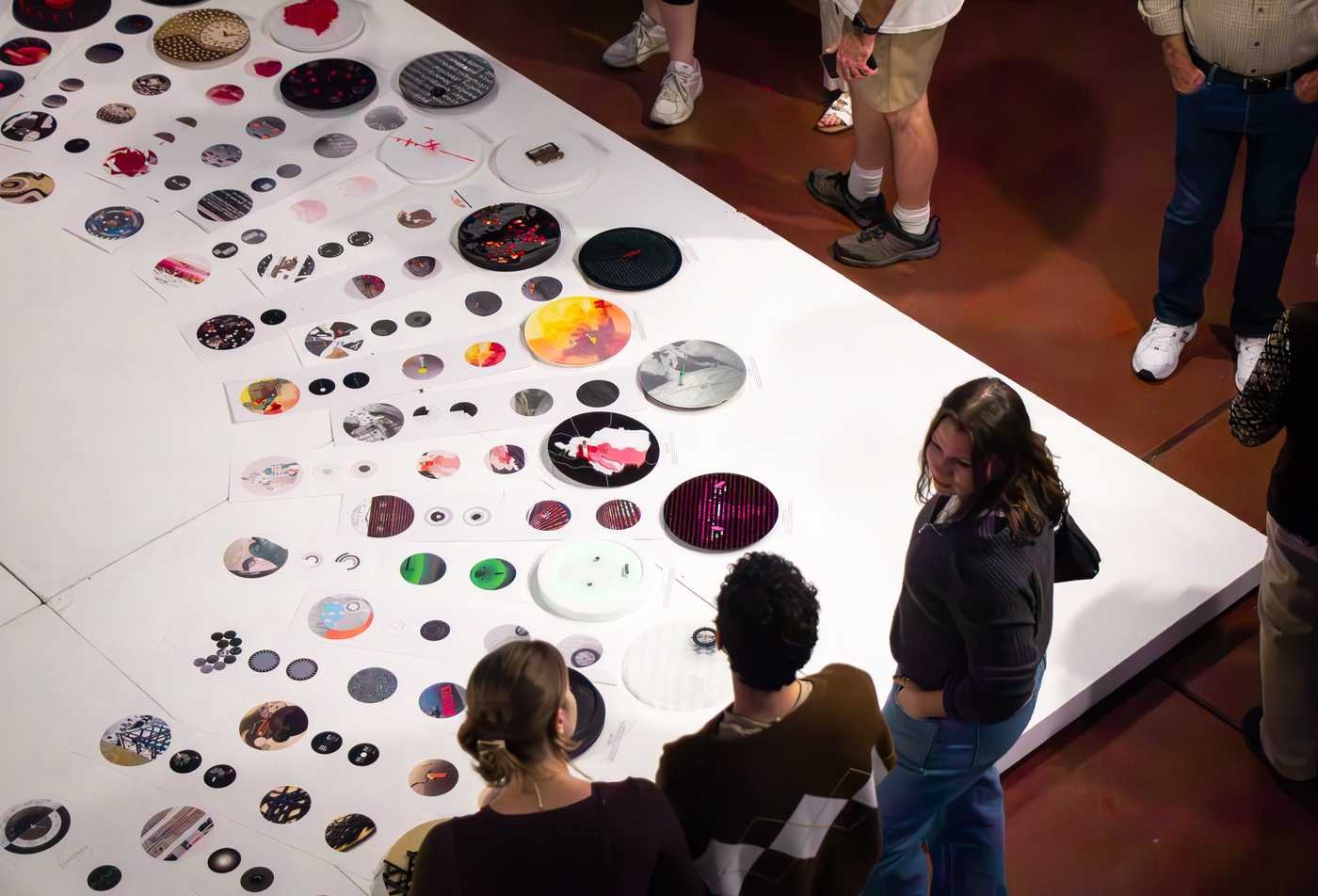 Students attend a graphic design showcase, showcasing the hands-on projects in the BSD in Graphic Design.