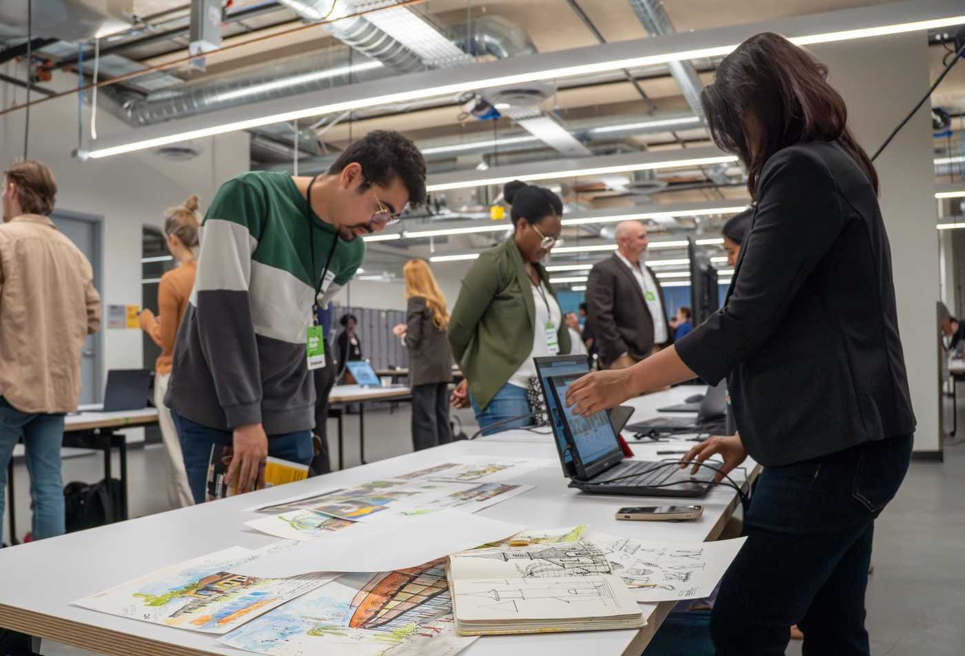Students examine architecture projects, showcasing hands-on learning in the Urban Design, MUD.