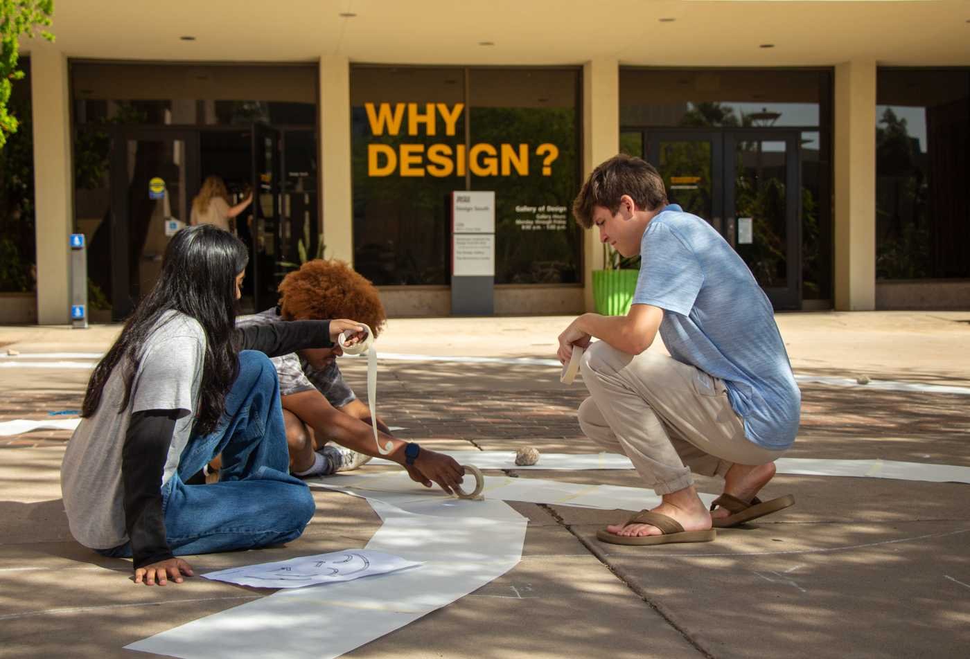 Three students in The Design School collaborating on a project on the ASU Tempe campus, showcasing hands-on learning in the BSD in Architectural Studies.